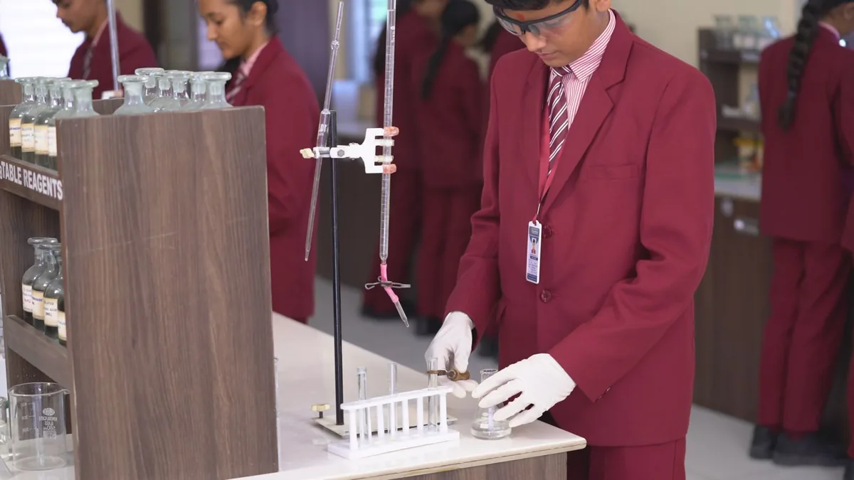 Students conducting an experiment in a chemistry laboratory in India