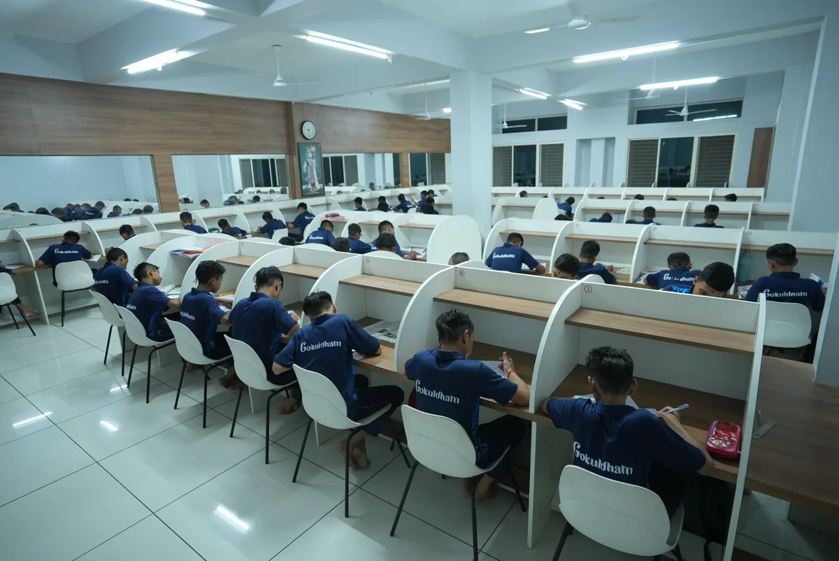 Students reading and studying independently in a library in Gujarat, India